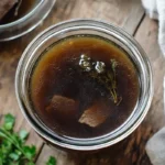 Beef broth in a clear glass jar