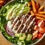 Burger bowl with grilled beef, avocado, and fresh vegetables