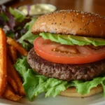 Healthy hamburger with avocado, lettuce, and sweet potato fries